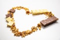 Heart shape from granola, muesli with dried banana, other fruits and white/ milk chocolate. Side view. Healthy and balanced diet