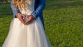 Heart shape with groom`s hands on the dress of the bride Royalty Free Stock Photo