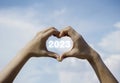 Heart shape hand on blue sky and fluffy cloud background, concept of love, relationship and romantic. Royalty Free Stock Photo