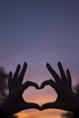 Heart shape hands at dusk silhouette sunset sky Royalty Free Stock Photo