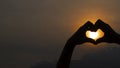 Heart shape with hands silhouette made against the sun Royalty Free Stock Photo