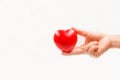 Heart shape in the helping hand on white background. Heart illness, disease protection, proactive checkup, mind diagnosis, sick