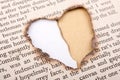 Heart shape hole burnt on paper Royalty Free Stock Photo