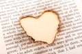 Heart shape hole burnt on paper Royalty Free Stock Photo