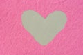 Heart shape hole on piece on pink paper Royalty Free Stock Photo