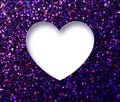 Heart shape hole through shiny glittering purple paper. White blank space for text