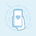 Heart shape icon on smartphone screen. Hand holding smartphone. Royalty Free Stock Photo