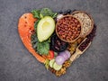 Heart shape of ketogenic low carbs diet concept. Ingredients for healthy foods selection on dark stone background. Balanced