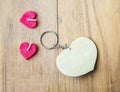 Heart shape key chain and candle on wooden board Royalty Free Stock Photo