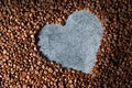 Heart shape made from brown and black roasted coffee beans or grains background Royalty Free Stock Photo