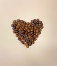 Heart shape made of coffee beans on background. Flat lay. Symbol of Love to coffee. Royalty Free Stock Photo