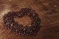 Heart shape made from coffee beans on the dark wooden background Royalty Free Stock Photo