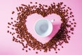 Heart shape made from coffee beans with empty cup for coffee inside Royalty Free Stock Photo