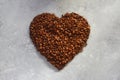 Heart shape made of coffee beans on stone background. Concept of Love to coffee. Royalty Free Stock Photo