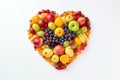 Heart shape made of different fruits and berries isolated on white background. Heart symbol. Fruit diet and healthy organic food Royalty Free Stock Photo