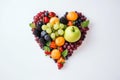 Heart shape made of different fruits and berries isolated on white background. Heart symbol. Fruit diet and healthy organic food Royalty Free Stock Photo