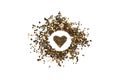Heart shape made from dried tea. Dry tea circle isolated on white background. Circle of dried tea buds with heart inside Royalty Free Stock Photo