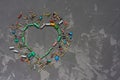 Heart shape made from electronic components on gray concrete background. Symbol of love from resistors and capacitors. Happy