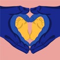 Heart shape made with hands of father, mother and a baby's feet. Concept of support, peace, family happiness. Made