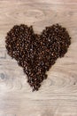 Heart shape made out of coffee beans on top of a table Royalty Free Stock Photo