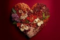 Heart. Love. Heart shape made out of flowers, orchids, herbs and leaves on red background Royalty Free Stock Photo