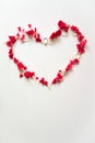 Heart shape made by red carnation petals with ring