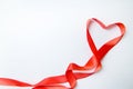 Heart shape made of red ribbon on white wooden Background. copy space - Valentines and 8 March Mother Women& x27;s Day concept Royalty Free Stock Photo