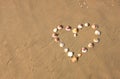 Heart shape made from sea shells on sandy beach. room for text. Royalty Free Stock Photo