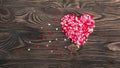 Heart shape made of small hearts on a wooden background. Royalty Free Stock Photo