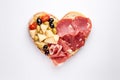 Heart shape made of traditional Spanish tapas, ham, salami, cheese and olives with bread. Flat lay with assorted appetizers for Royalty Free Stock Photo