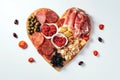 Heart shape made of traditional Spanish tapas, ham, salami, cheese and olives with bread. Flat lay with assorted appetizers for Royalty Free Stock Photo