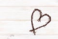 Heart shape made of twigs - wooden symbol of love on a white background