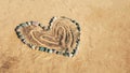 The heart shape is made from various stones on the sand. Royalty Free Stock Photo