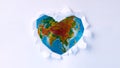 Heart shape made by white paper over Earth globe background. selective focus. love nature and Earth concept Royalty Free Stock Photo