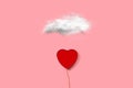 A heart shape open box and in the shape of a balloon with a white cloud on a pink background Royalty Free Stock Photo