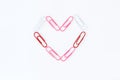 Heart shape by paper clips on white background Royalty Free Stock Photo