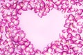 Heart shape of pink petals on pink background. Valentine`s day with beautiful rose petals. Love backdrop Royalty Free Stock Photo