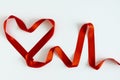 heart shape and heart rate are lined with red satin ribbon on a white background. love, medicine and life insurance concept.