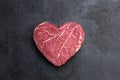 Heart shape raw fresh beef steak on metal background Royalty Free Stock Photo