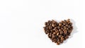 Heart shape of Robusta, Arabica coffee beans isolated on white background, banner, copy space. Coffee beans for latte Royalty Free Stock Photo