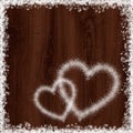 Heart shape from snow on dark wood background