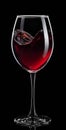 heart shape splash from red wine in glass isolated on black Royalty Free Stock Photo