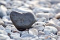 Heart shape stone against background of beach. Summer sunny day. Love, wedding and Valentine day concept. Finding Royalty Free Stock Photo