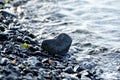 Heart shape stone against background of beach. Summer sunny day. Love, wedding and Valentine day concept. Finding Royalty Free Stock Photo