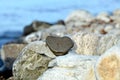 Heart shape stone against background of beach. Summer sunny day. Love, wedding and Valentine day concept. Finding Royalty Free Stock Photo