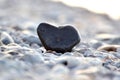Heart shape stone against background of beach. Summer sunny day. Love, wedding and Valentine day concept. Finding Royalty Free Stock Photo
