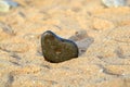 Heart shape stone against background of beach. Summer sunny day. Love, wedding and Valentine day concept. Finding Royalty Free Stock Photo