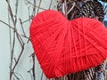 heart shape symbol made from wool.Red knitting yarn heart shaped. Valentines day minimal concept. Greeting card Royalty Free Stock Photo