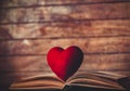Heart shape toy on open retro book Royalty Free Stock Photo