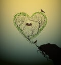 Heart shape tree with bids and nest growing at the edge of the rock, tree of love and care, Valentine symbol,